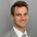 Headshot of Kyle Kane, a Health Informatics and Bioinformatics (HIB) student at GVSU, smiling at the camera in front of a plain gray background.